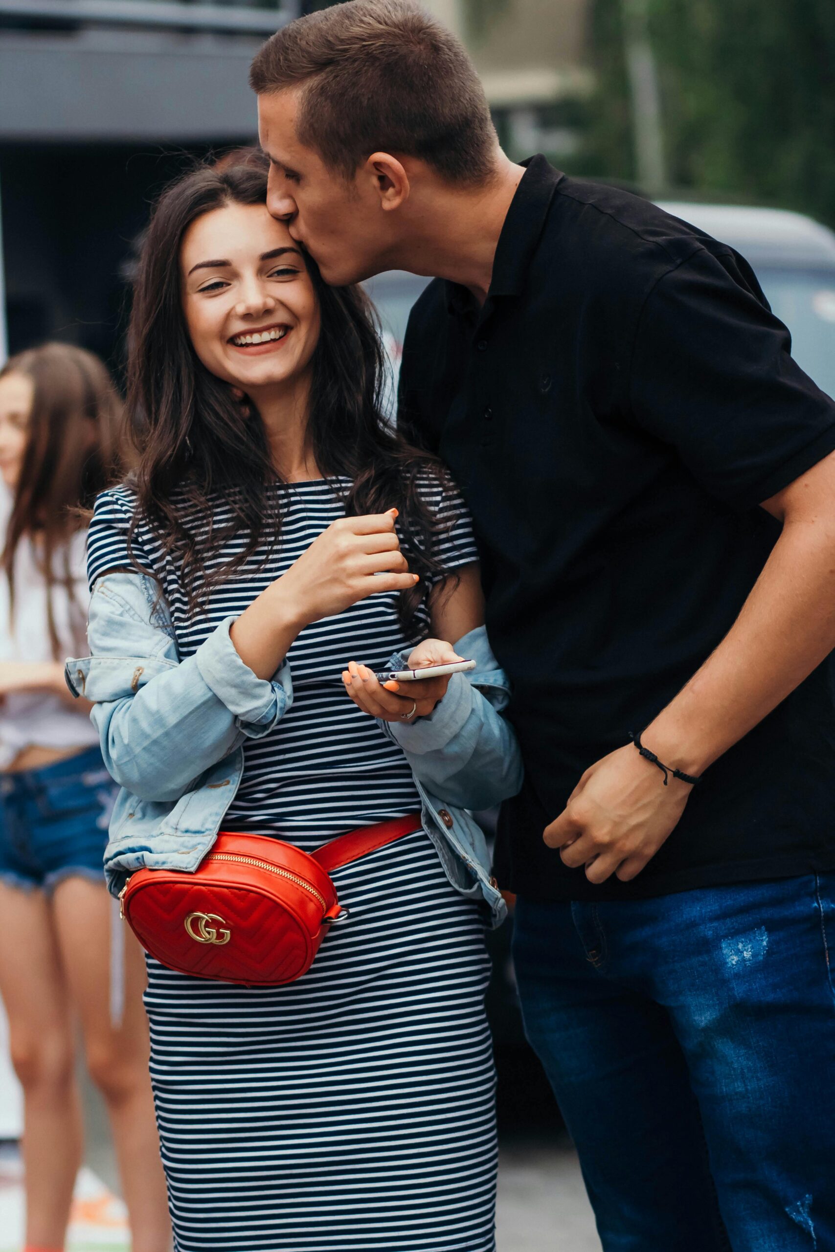Smiling couple sharing an affectionate moment outdoors.